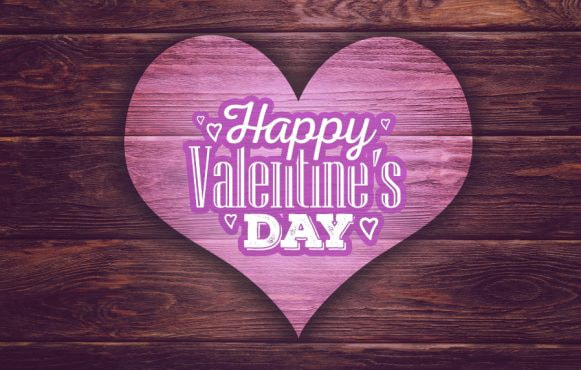 O inimă roz cu mesajul "Happy Valentine's Day" pe o placă