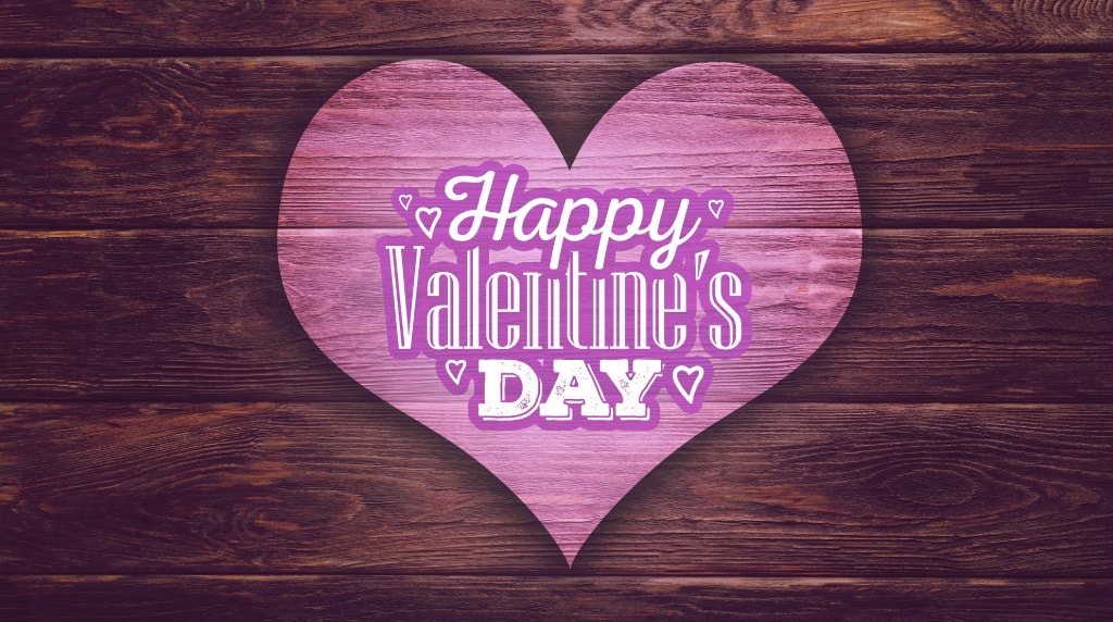 O inimă roz cu mesajul "Happy Valentine's Day" pe o placă