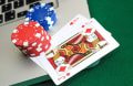 Laptop with casino cards and chips