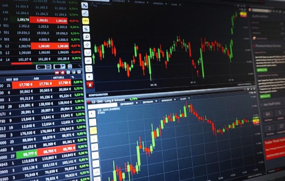Laptop displaying trading charts and financial data